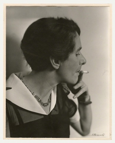 The black-and-white photo shows Erika Mann in profile as she smokes a cigarette.